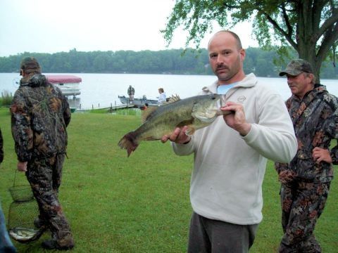 An angler holding a Largemouth Bass caught on Duck Lake