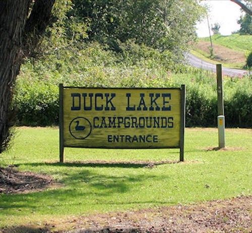 Duck Lake Campgrounds carved wooden entrance sign with duck emblem