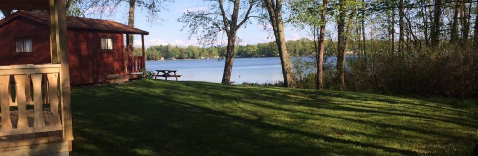 A setting with a spectacular view — a lakeside cabin and lawn overlooking Duck Lake