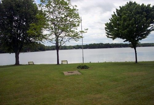 Waterfront lawn with benches at Duck Lake Campground